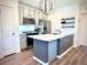 Modern kitchen features sleek gray cabinets, stainless steel appliances, and a central island at 5027 N Walden Way, Denver, CO 80249