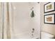 Simple bathroom with white tile and a bathtub at 8867 W Floyd Ave, Lakewood, CO 80227