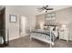 Charming bedroom with a white metal bed frame and ceiling fan at 8867 W Floyd Ave, Lakewood, CO 80227