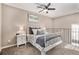 Bright bedroom with a ceiling fan and a white metal bed frame at 8867 W Floyd Ave, Lakewood, CO 80227