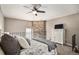 Spacious bedroom with stone accent wall and ceiling fan at 8867 W Floyd Ave, Lakewood, CO 80227