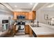 Stainless steel appliances and light wood cabinets in this kitchen at 8867 W Floyd Ave, Lakewood, CO 80227