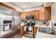 Updated kitchen with stainless steel appliances and wood cabinets at 8867 W Floyd Ave, Lakewood, CO 80227