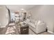 Open concept living area with a gray sectional sofa and rustic coffee table at 8867 W Floyd Ave, Lakewood, CO 80227