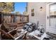 Small patio with wooden chairs and a grill at 8867 W Floyd Ave, Lakewood, CO 80227