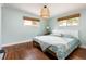 Serene bedroom with light-blue walls, hardwood floors, and a king-size bed at 5080 S Inca Dr, Englewood, CO 80110