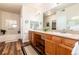Bathroom boasts dual sinks, wood cabinets, a well-lit vanity, and a soaking tub at 6222 Kilmer Loop # 103, Golden, CO 80403