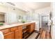 Spacious bathroom featuring dual sinks, a vanity area, and a separate shower stall at 6222 Kilmer Loop # 103, Golden, CO 80403