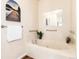 Elegant bathroom featuring a deep soaking tub with jets, decorative accents, and safety grab bars at 6222 Kilmer Loop # 103, Golden, CO 80403
