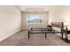 Spacious bedroom featuring plush carpet, a bright window, and contemporary bedside tables at 6222 Kilmer Loop # 103, Golden, CO 80403