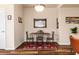 Dining area with rustic table, seating for four, and decorative rug at 6222 Kilmer Loop # 103, Golden, CO 80403
