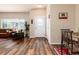 Inviting foyer with wood floors, decorative door, and view to living room at 6222 Kilmer Loop # 103, Golden, CO 80403