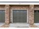Exterior of a garage featuring a brick facade and multi-paned doors at 6222 Kilmer Loop # 103, Golden, CO 80403