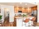 Well-lit kitchen with stainless steel appliances, island, and wooden cabinetry at 6222 Kilmer Loop # 103, Golden, CO 80403