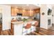 Open kitchen with stainless steel appliances, island, and adjacent living space at 6222 Kilmer Loop # 103, Golden, CO 80403