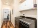 Bright laundry room with modern washer and dryer and ample cabinet space at 6222 Kilmer Loop # 103, Golden, CO 80403