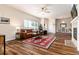 Open-concept living room with wood floors, fireplace, and access to dining area at 6222 Kilmer Loop # 103, Golden, CO 80403