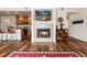 Cozy living room with a fireplace, wood floors, and open view into kitchen at 6222 Kilmer Loop # 103, Golden, CO 80403