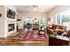 Comfortable living room with fireplace, TV, wood floors, and an open layout at 6222 Kilmer Loop # 103, Golden, CO 80403