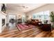 Spacious living room featuring beautiful wood floors, fireplace, and an adjacent study at 6222 Kilmer Loop # 103, Golden, CO 80403