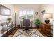 Bright office space with a large window, desk and chair, and warm decorative rug at 6222 Kilmer Loop # 103, Golden, CO 80403