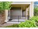 Inviting covered porch with black railing and stone accents, perfect for enjoying the outdoors at 6222 Kilmer Loop # 103, Golden, CO 80403