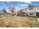 Expansive backyard with a deck, shed, and mature trees at 15691 E Atlantic Cir, Aurora, CO 80013