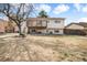 Large backyard with a wooden deck, a storage shed, and mature trees at 15691 E Atlantic Cir, Aurora, CO 80013