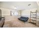 Finished basement featuring a futon, window and access to a ladder shelf at 15691 E Atlantic Cir, Aurora, CO 80013