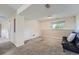 Finished basement featuring carpeted floors, a bright window, and a leather sofa at 15691 E Atlantic Cir, Aurora, CO 80013