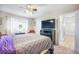 Cozy bedroom with a ceiling fan, plush bedding, and abundant natural light from a large window at 15691 E Atlantic Cir, Aurora, CO 80013
