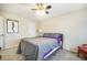 Comfortable bedroom features a ceiling fan, gray and purple bedding, and ample natural light at 15691 E Atlantic Cir, Aurora, CO 80013