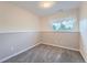 This bedroom features carpeted floors, neutral walls, and a bright window at 15691 E Atlantic Cir, Aurora, CO 80013