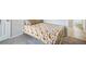 A cozy bedroom with a patterned bedspread, neutral walls, and soft gray carpeting exudes warmth and comfort at 15691 E Atlantic Cir, Aurora, CO 80013