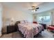 This bedroom features carpeted floors, a ceiling fan, and plenty of natural light at 15691 E Atlantic Cir, Aurora, CO 80013