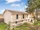 Tan two-story home with well-maintained lawn and mature trees at 15691 E Atlantic Cir, Aurora, CO 80013