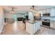 Stylish kitchen showcasing stainless steel appliances and an adjacent open living space at 15691 E Atlantic Cir, Aurora, CO 80013