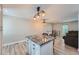 Kitchen island with granite countertop and white cabinets at 15691 E Atlantic Cir, Aurora, CO 80013