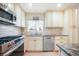 Well-lit kitchen featuring stainless steel appliances, light wood floors, and neutral-toned cabinets and countertops at 15691 E Atlantic Cir, Aurora, CO 80013