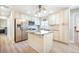 Open kitchen with stainless appliances, granite countertops, light-colored cabinetry, and an island at 15691 E Atlantic Cir, Aurora, CO 80013
