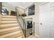 A wood and metal staircase leads to the upper level with neutral walls and white doors, with two lounge areas at 15691 E Atlantic Cir, Aurora, CO 80013