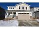 Two-story house with beige siding, stone accents, and a two-car garage at 24625 E 41St Ave, Aurora, CO 80019