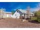 A backyard view showcasing the house, a wooden fence, and wood chip ground cover at 4087 S Clarkson S St, Englewood, CO 80113