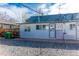View of the back of the house showing the back door and a gravel yard at 4087 S Clarkson S St, Englewood, CO 80113