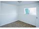 Inviting bedroom with neutral carpet, white walls, and a window offering natural light at 4087 S Clarkson S St, Englewood, CO 80113