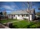 Charming home with a well-maintained front yard and a quaint wooden fence at 4087 S Clarkson S St, Englewood, CO 80113