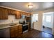 Modern kitchen with stainless steel appliances, granite countertops, and wood cabinets at 4087 S Clarkson S St, Englewood, CO 80113
