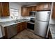 Well-lit kitchen with stainless steel appliances, granite countertops, and wood cabinets at 4087 S Clarkson S St, Englewood, CO 80113