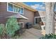 Wood deck featuring outdoor seating area, grill, umbrella, and shade tree at 7492 W Cedar Cir, Lakewood, CO 80226