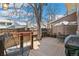 Wood deck featuring outdoor seating area, grill, and shade tree at 7492 W Cedar Cir, Lakewood, CO 80226